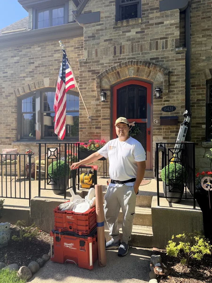 Isman, founder and owner of Benchmark Wallcovering, on a residential job